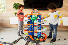 Load image into Gallery viewer, Hot Wheels City Ultimate Garage Track Set with 2 Toy Cars, Garage Playset Features Multi-Level Racetrack, Moving T-Rex Dino &amp; Storage for 100+ 1:64 Scale Vehicles, Toy Gift for Kids 3 Years &amp; Older
